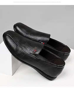 Detail view of black lychee leather men's loafers with metal trim and non-slip sole