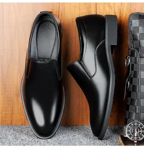 Detail of polished black leather men's formal loafers on luxury textured background