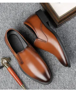 Detail view of brown leather loafers featuring gradient toe finish and slip-on design