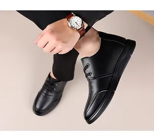 Close-up of black litchi grain leather men's business shoes with thick rubber soles