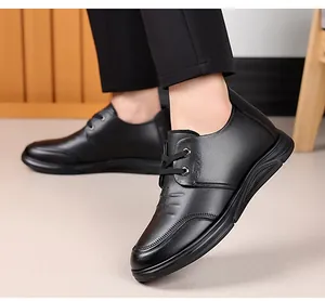 Close-up of black leather casual shoe with SPORT engraving and thick athletic sole
