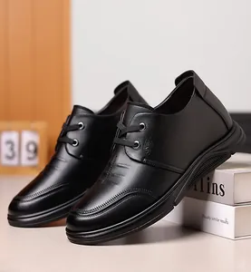 Detail of lychee pattern leather and branded logo on black men's elevator business shoe