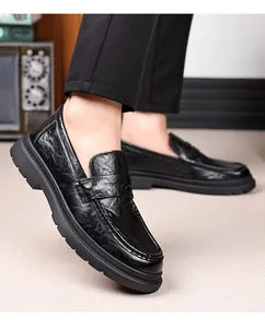 Detailed view of black textured leather loafers for men with thick rubber soles