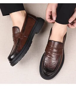Detailed top view of dark brown leather penny loafers with thick non-slip rubber soles