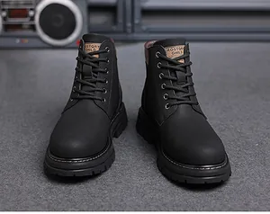 Detail of black high-top martin boots with six-eyelet lacing and thick rubber soles