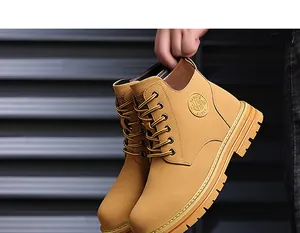 Detailed close-up of yellow nubuck leather work boots with deep tread rubber soles