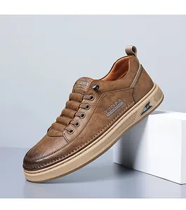 Detail view of brown textured leather men's sneakers with premium rubber sole on grey background
