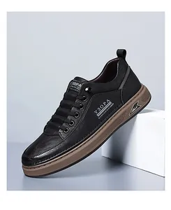 Detail of black pebbled leather texture and thick brown sole on trendy men's sneaker