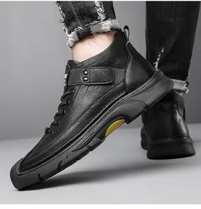 Detail of black leather casual boot with textured upper and decorative side snap button strap