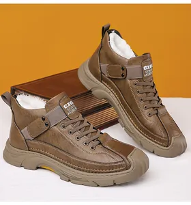 Detail view of men's brown outdoor winter boots with thick white faux fur lining and rubber sole