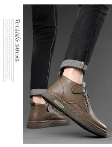 Detailed side view of brown leather tooling boots with thick rubber soles and stitch detail