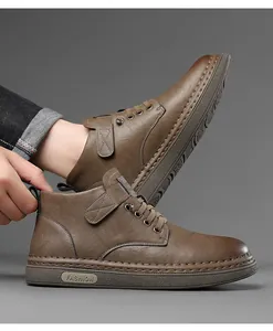 Detail of brown leather high-top boots with precision stitching and fashion sole logo