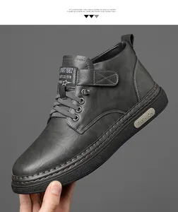 Detail view of dark grey leather high-top boot with velcro strap and durable rubber sole