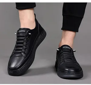 Detailed macro view of black leather men's casual shoes with brand logo and non-slip rubber sole