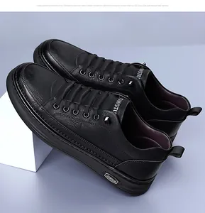 Detail of black leather casual shoe with litchi texture and metal STARR logo plaque