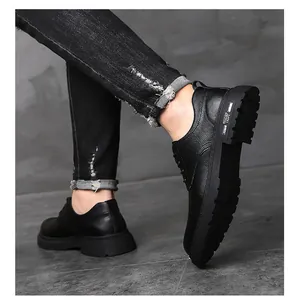 Detail of men's black leather platform shoe with textured finish and slip-resistant sole