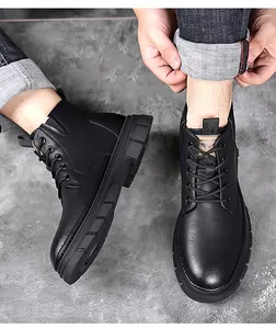 Close-up of black matte leather Martin boots with thick anti-slip rubber soles and laces
