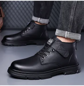 Close-up of black matte waterproof boots with thick rubber soles and non-slip texture