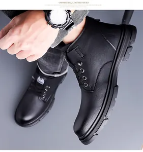 Detail view of black high-top snow boots with non-slip rubber soles and leather texture