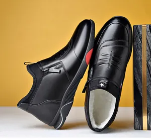 Detail of winter men's boots with warm fleece lining and side zipper closure in black
