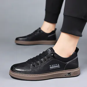 Men's retro low-top black leather sneakers with durable brown sole worn on feet