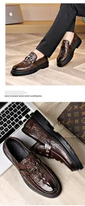 Close-up of brown crocodile embossed leather loafers with metal horsebit and thick rubber sole