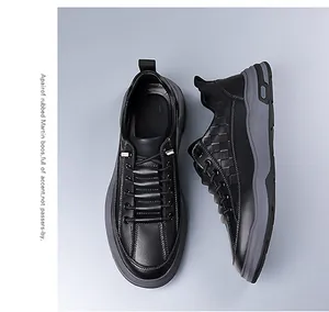 Detailed view of the woven plaid texture on a black leather casual men's platform sneaker