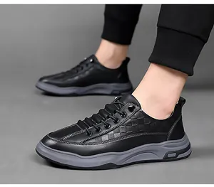 Detailed close-up of black leather casual shoes with checkered texture and thick soles