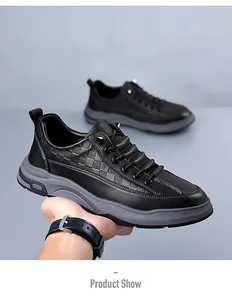 Detail of black leather casual men's sneakers featuring embossed pattern and thick grey sole