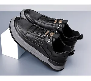 Close-up of black litchi grain leather men's sneakers with gray thick rubber soles