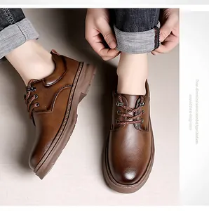 Detail of brown leather men shoes featuring woven laces and thick rubber soles