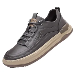 Men's dark taupe leather sneakers with beige thick rubber soles and side perforations