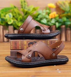 Detail of brown leather texture and convertible heel strap on men's beach sandals