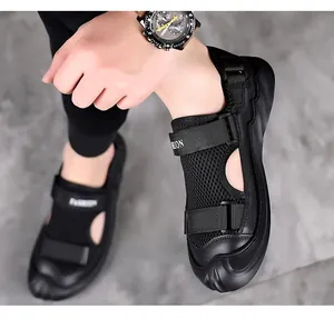 Detail of black men's sandals featuring breathable mesh and Velcro straps with fashion text
