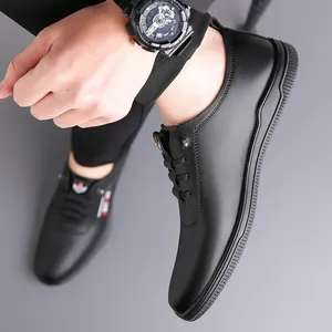 Men's black leather casual shoes with thick rubber soles and matching sports watch
