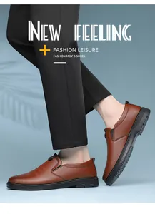 Close-up of brown leather loafers worn by a model against a light blue backdrop