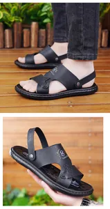 Detailed view of black men's sandals featuring golden 8X Fashion Sport text and stitching