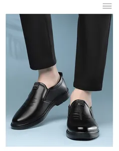 Macro detail of black leather loafers with silver CS metal logo and matte finish