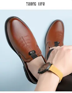 Close-up of brown leather slip-on loafer with textured grain and metallic CS detail