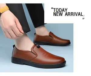 Detail of brown leather loafers featuring grain texture and flexible black rubber sole
