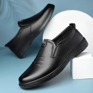 Men's black leather slip-on loafers with metal buckle on a blue background