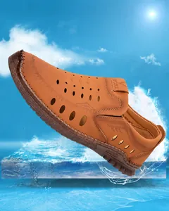Macro view of brown hollow-out leather sandals with breathable holes and rubber sole