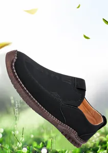 Detail of hand-stitched seams on men's black loafers with slip-on leather design