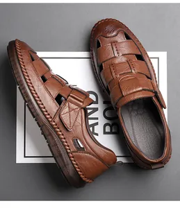 Detailed close-up of brown leather men's sandals with hand-stitched seams and hollow design