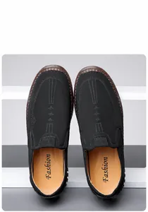 Detail view of men's slip-on loafers showing matte black leather texture and fine stitching