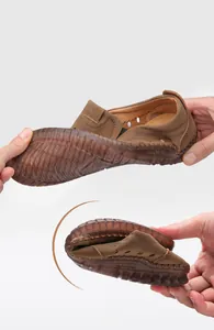 Macro shot showing extreme flexibility of the brown men shoe with soft rubber sole