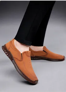 Detail view of brown leather loafers featuring fine stitching and the SPORT logo on the side