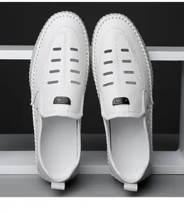 Close-up of white breathable hollow leather loafers with stitching details and logo