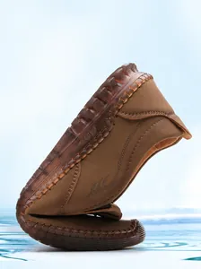 Detail of flexible brown leather sandal showing high flexibility and soft bendable sole