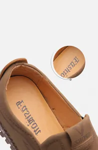 Macro detail of breathable perforated inner lining and cushioned insole of men's leather loafers